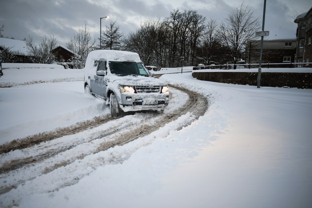 ALEXANDRIA, UNITED KINGDOM - MARCH 01: A 4x4 makes its way along the A813 on March 1, 2018 in Alexandria, Scotland. People have been warned to not to make unnecessary journeys as the Met office issues a red weather be aware warning for parts of Wales and South West England following the one currently in place in Scotland. (Photo by Jeff J Mitchell/Getty Images)