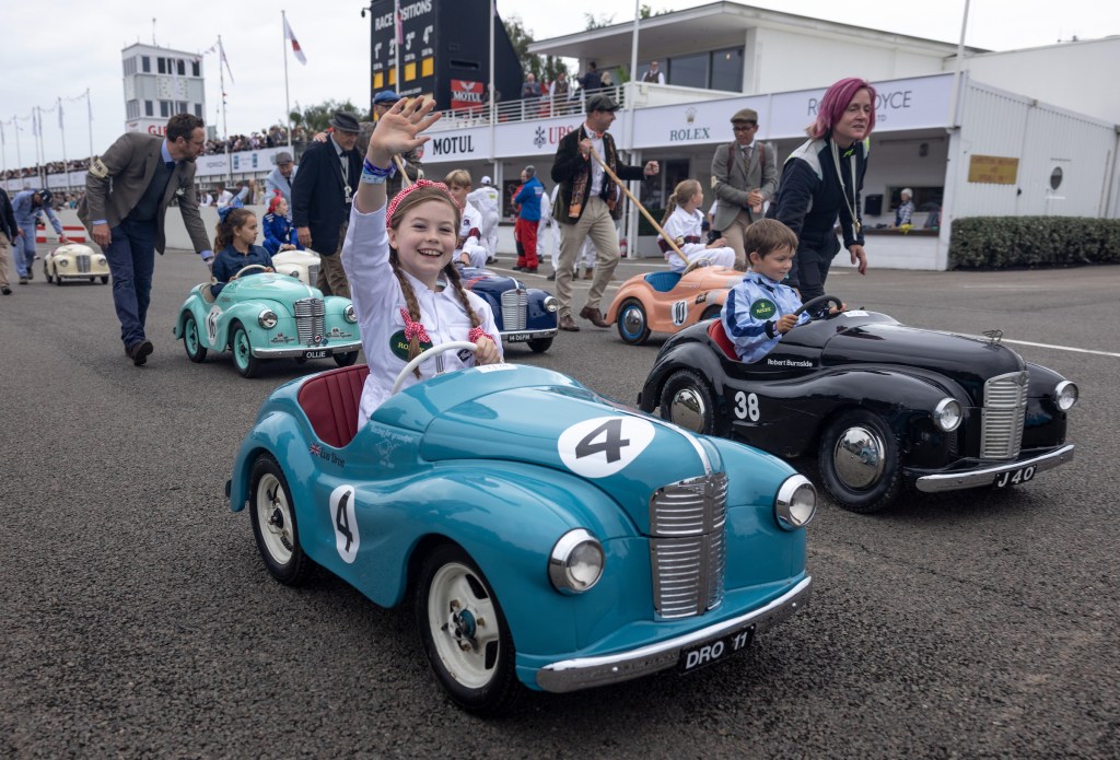 Eva Dron, the daughter of Driving.co.uk editor Will Dron, waves to the crowds ahead of the 2024 Settrington Cup part 1. Photo: © Rolex/ Felix Diemer