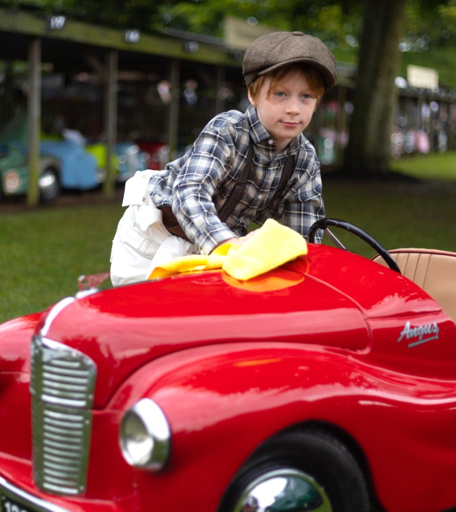 A mechanic polishes one of the Settrington Cup J40 pedal cars. Photo: Peter Tarry for The Sunday Times