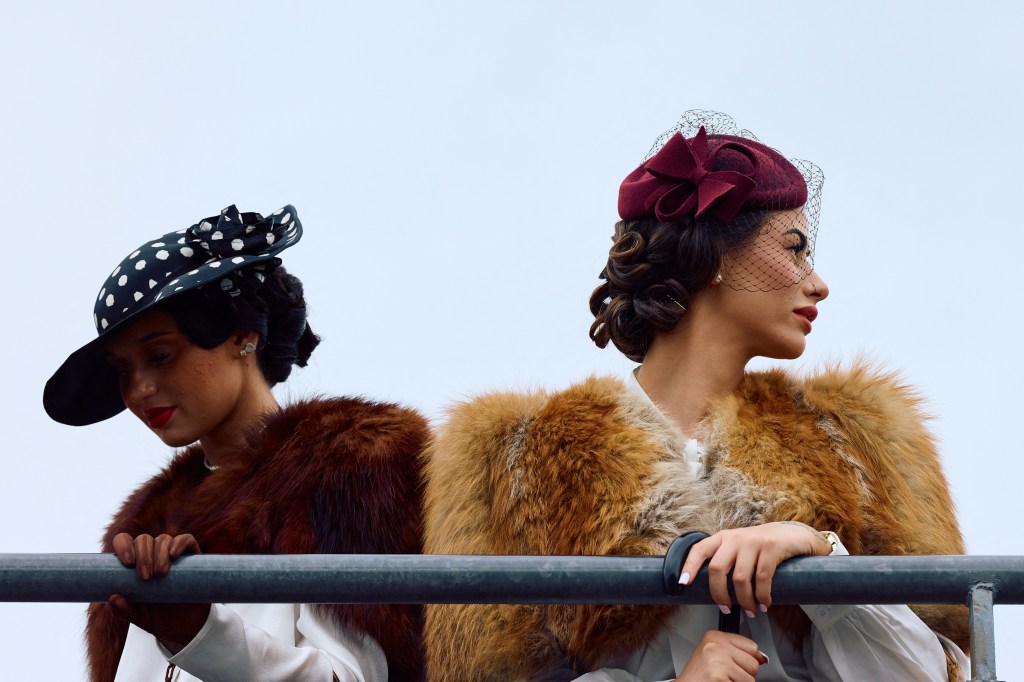 Furs across the line: ladies watch the action on track. Photo: Benjamin Cremel/ AFP via Getty Images