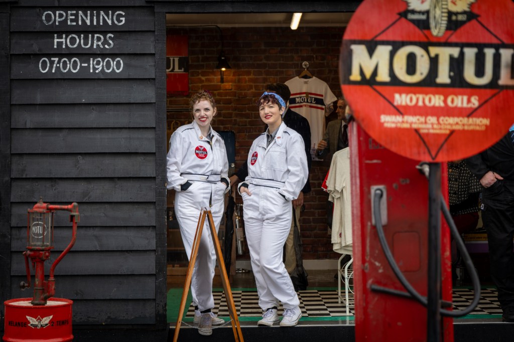 Two attendants smile for the camera at the Motul garage. This is a mock-up filling station but at the real thing, all the racing cars were topped up with sustainable fuels. Photo: Tristan Fewings via Getty Images