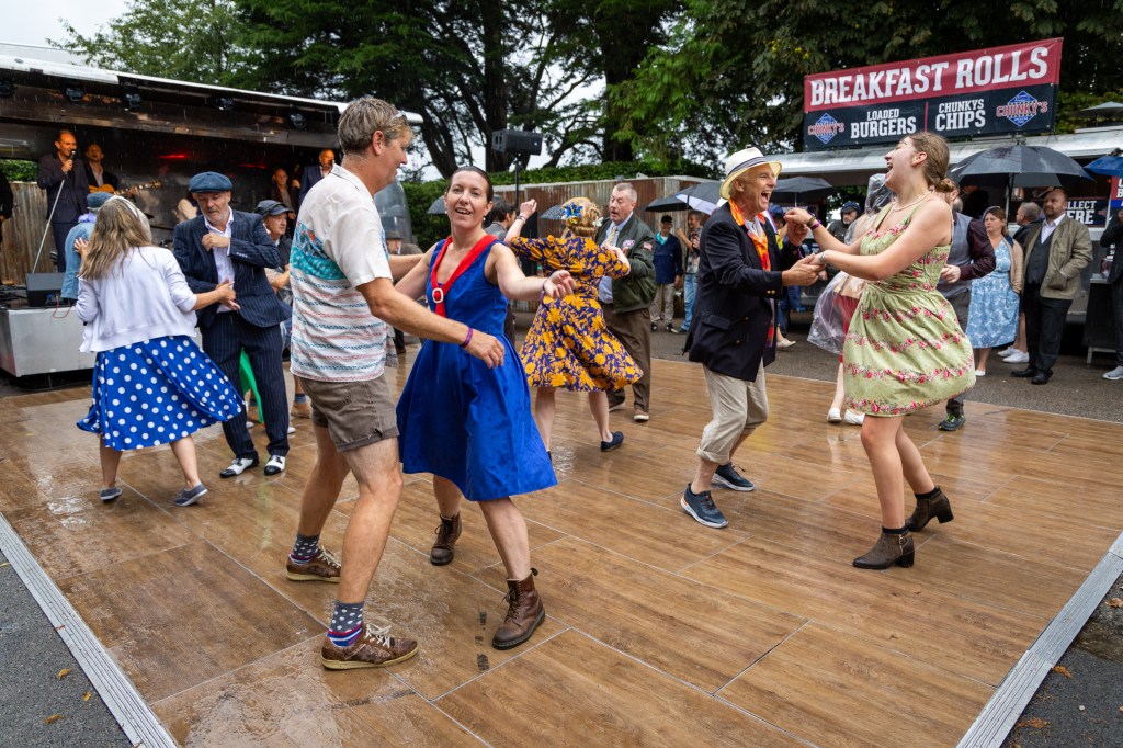 The heavy rain didn't stop people dancing on day one of the 2024 Goodwood Revival. Photo: Tristan Fewings via Getty Images