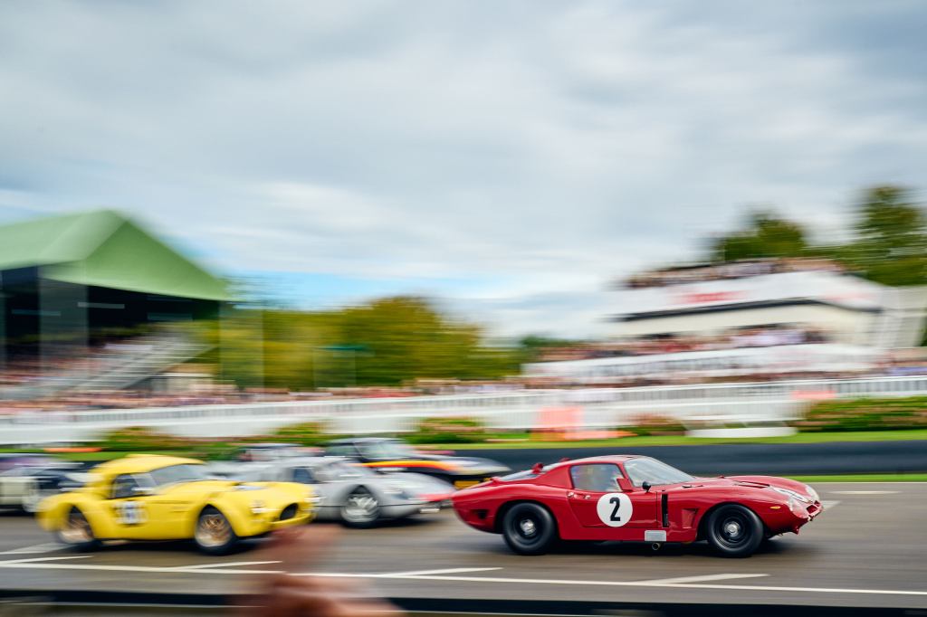 A Bizzarrini 5300GT, driven by Matt Neal and Joe Twyman, ahead of a gaggle of 1960-1964 closed-cockpit GT & protoype cars in the Royal Automobile Club TT Celebration. Photo: Jack Beasley for Goodwood.