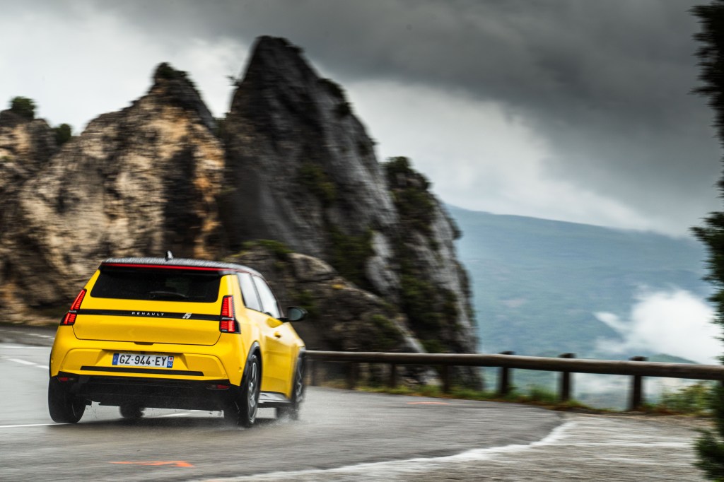 Renault 5 cornering in wet on mountain road