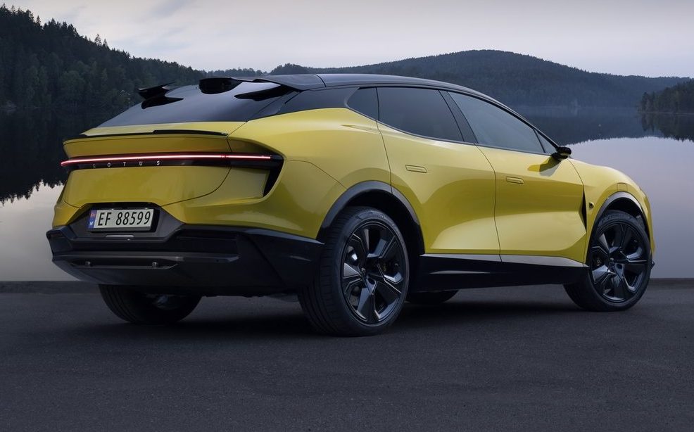 Lotus Eletre S in yellow, static rear 3/4 view with lake background