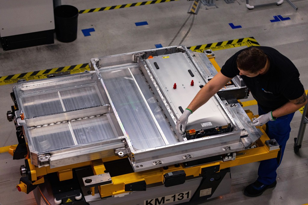 An employee fixes the cell block into the lower housing section of an electric vehicle battery at an Accumotive GmbH plant, a subsidiary of Mercedes-Benz AG, in Kamenz, Germany, on Wednesday, March 22, 2023. Mercedes is trying to focus on its top-end vehicles such as the S-Class sedan to bolster profits and help fund its multi-billion-euro shift to electric vehicles. Photographer: Krisztian Bocsi/Bloomberg via Getty Images