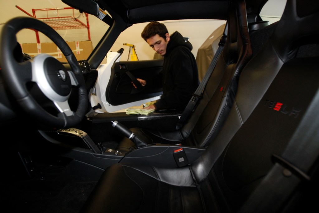 Johnny Aragon doing detailing on a Tesla on Monday, December 14, in Menlo Park, CA. (Photo By Liz Hafalia/The San Francisco Chronicle via Getty Images)