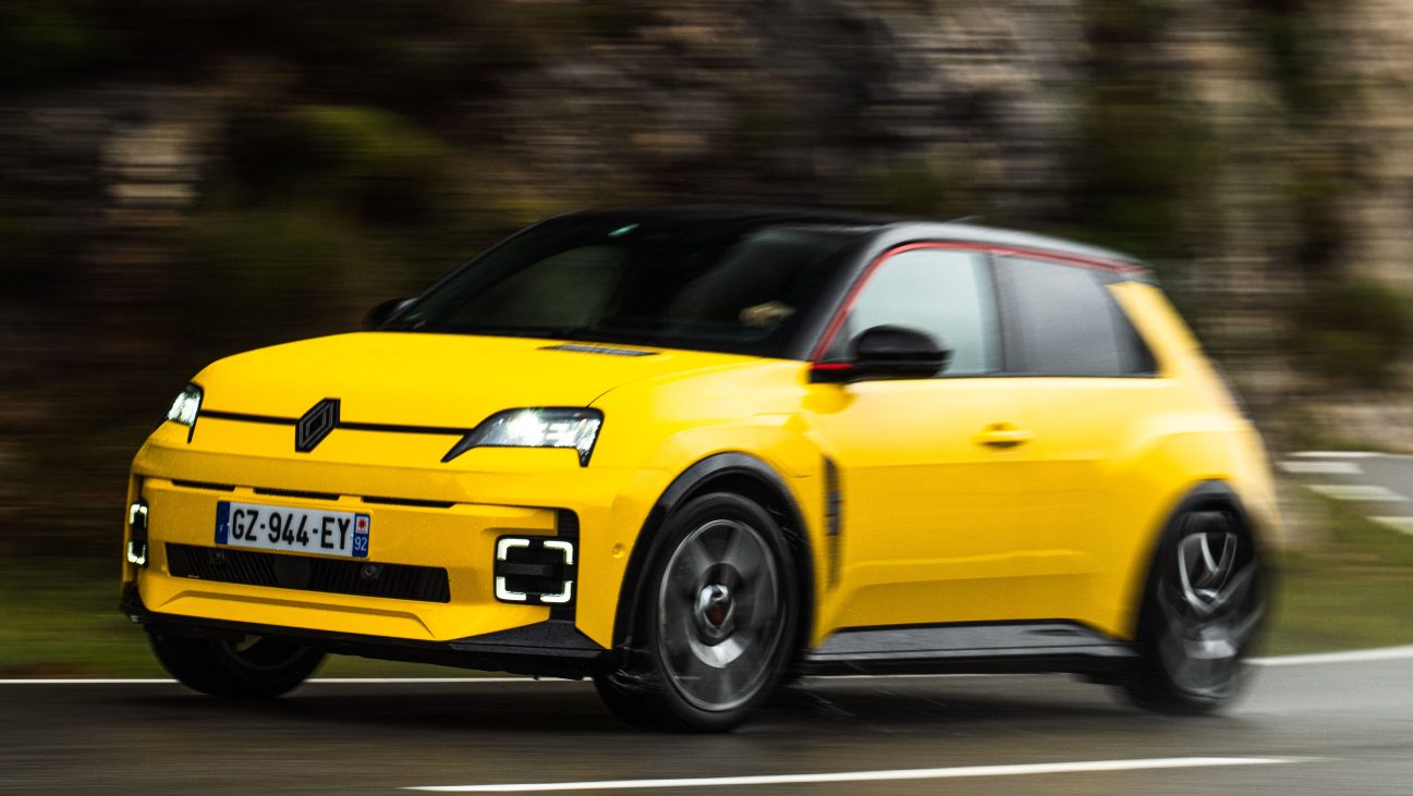 2024 Renault 5 in yellow, cornering on a mountain road