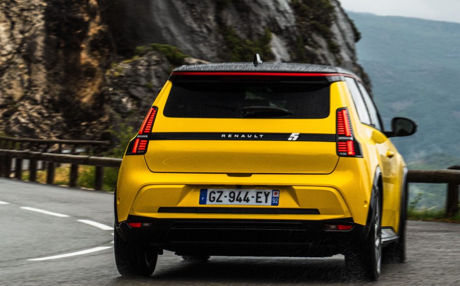 Rear view of the 2024 Renault 5 in yellow, on a mountain road