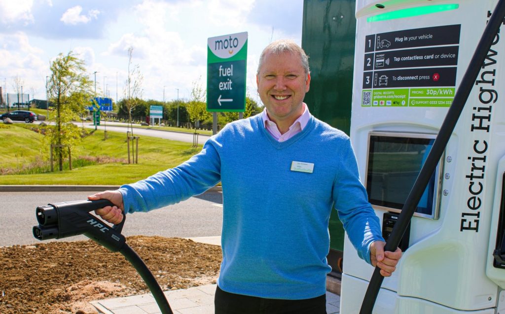 Moto Services Rugby Chief Executive Ken McMeikan with EV charger - pic by Tom Stables